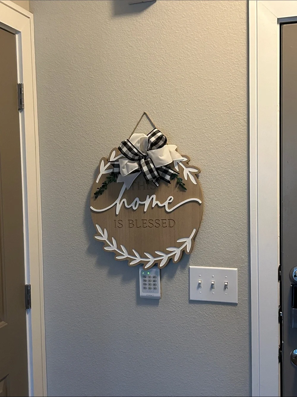 'This Home Is Blessed' Wood Wall Sign with Black Buffalo Check Bow